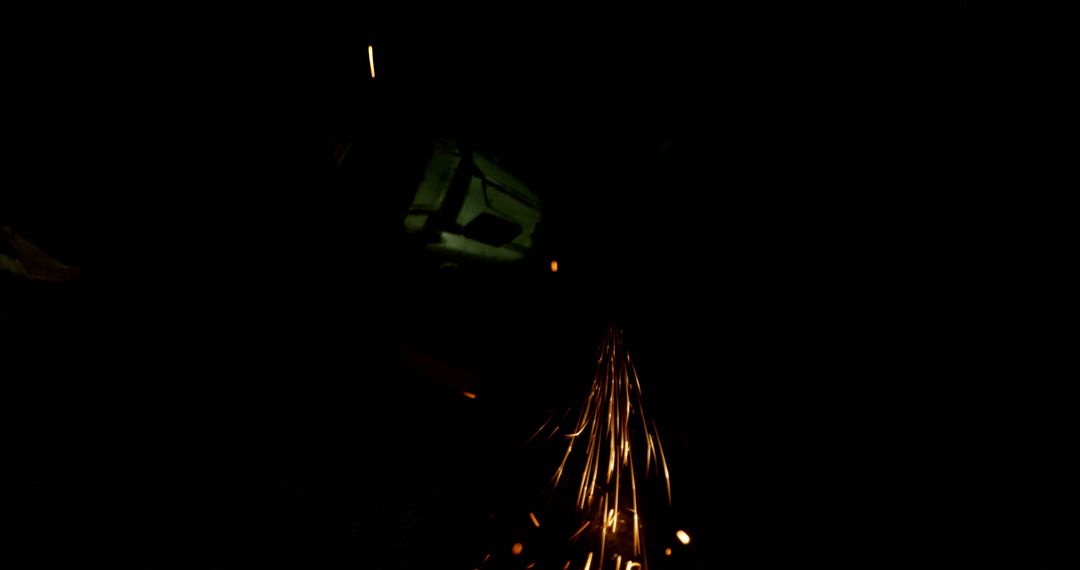 Worker Using Grinder Producing Sparks in Dark Environment - Free Images, Stock Photos and Pictures on Pikwizard.com