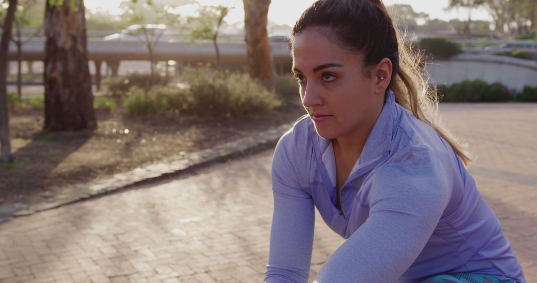 Determined Female Athlete Stretching Outdoors at Sunrise - Free Images, Stock Photos and Pictures on Pikwizard.com