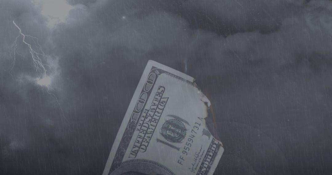 Burning Dollar Bill in Stormy Sky with Lightning