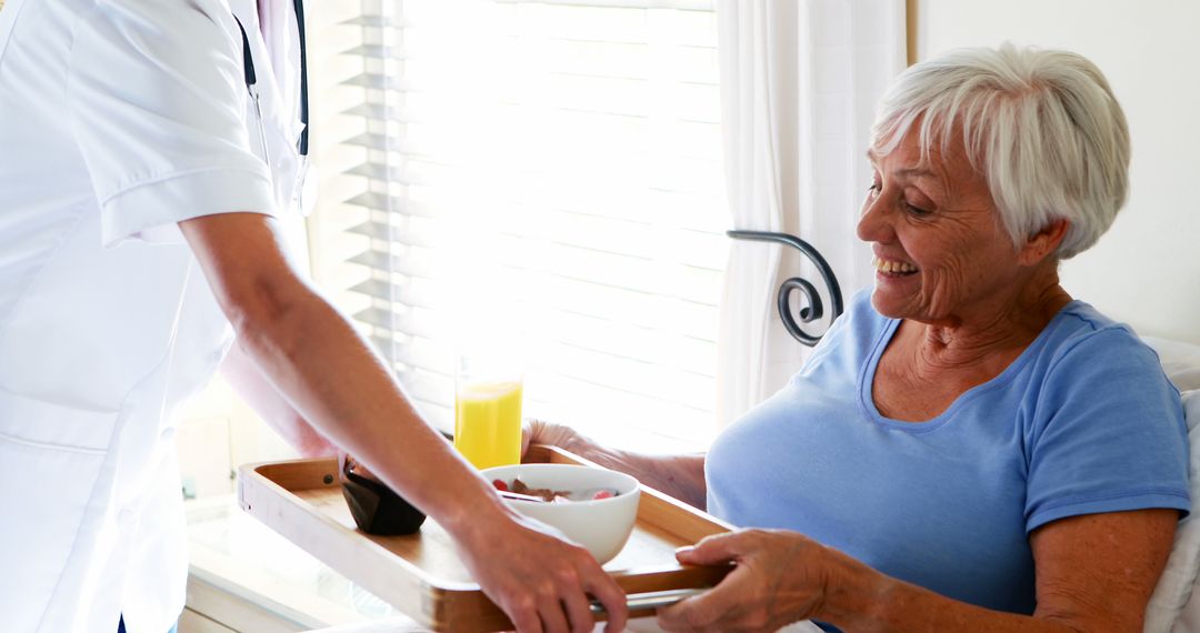 Nurse Bringing Breakfast to Senior Woman in Care Home - Free Images, Stock Photos and Pictures on Pikwizard.com