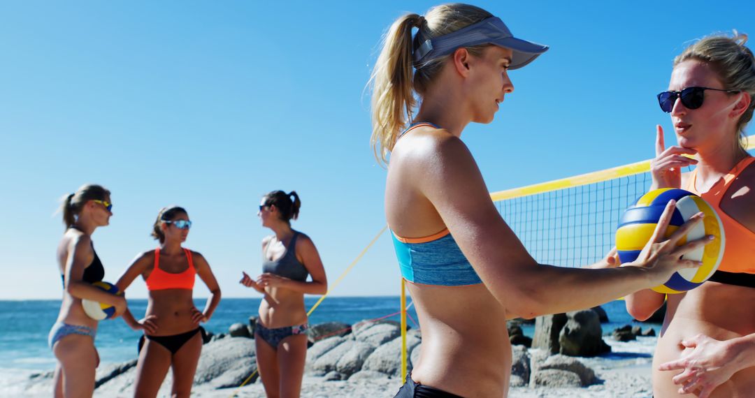 Female Beach Volleyball Players Warming Up and Discussing Tactics - Free Images, Stock Photos and Pictures on Pikwizard.com