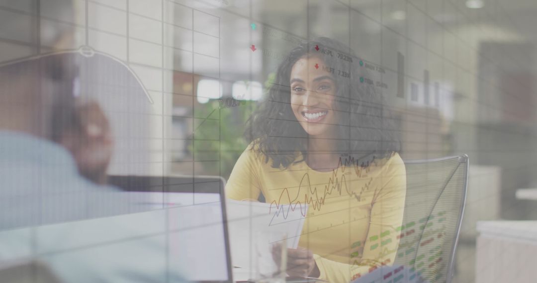 Smiling Colleagues Analyzing Financial Data in Modern Office