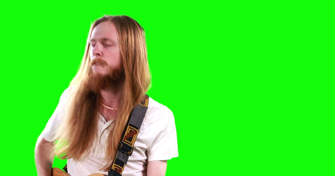 Guitarist playing electric guitar on green screen - Free Images, Stock Photos and Pictures on Pikwizard.com