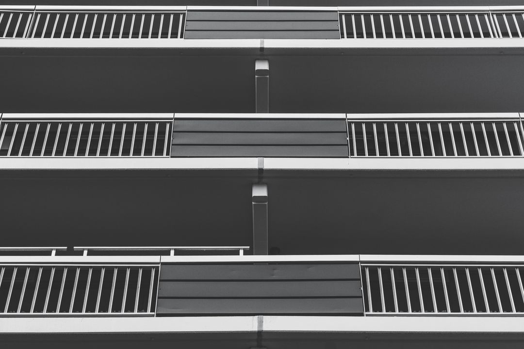 Monochrome perspective of modern condo building facade with balconies