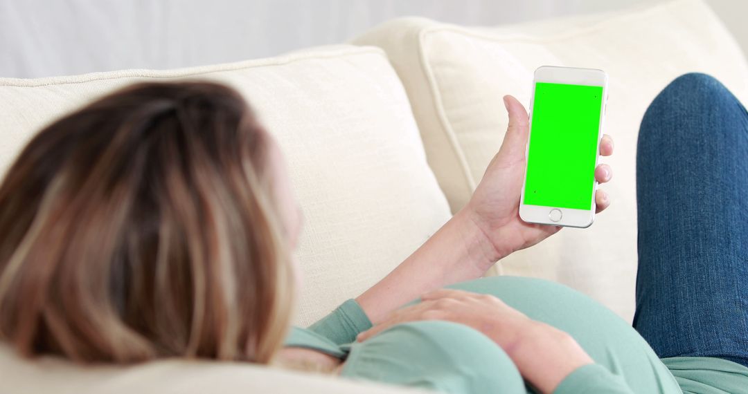 Pregnant Woman Relaxing on Couch Using Smartphone with Green Screen - Free Images, Stock Photos and Pictures on Pikwizard.com