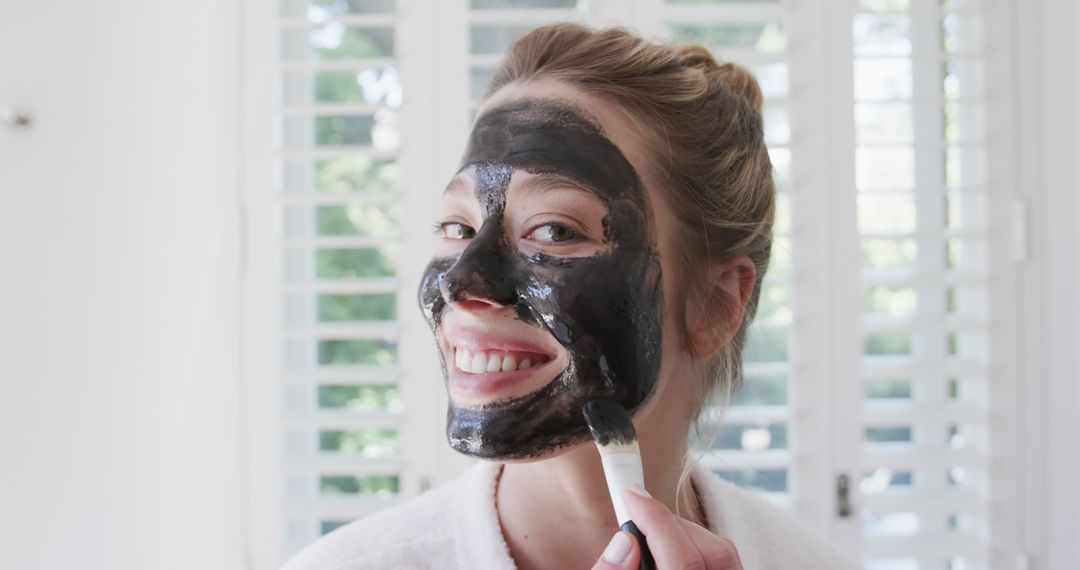 Joyful Woman Applying Facial Mask at Home Spa - Free Images, Stock Photos and Pictures on Pikwizard.com