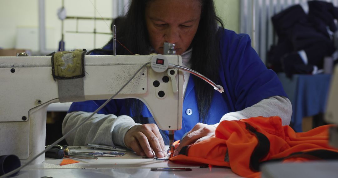 Female Garment Worker Sewing Fabric with Industrial Sewing Machine - Free Images, Stock Photos and Pictures on Pikwizard.com