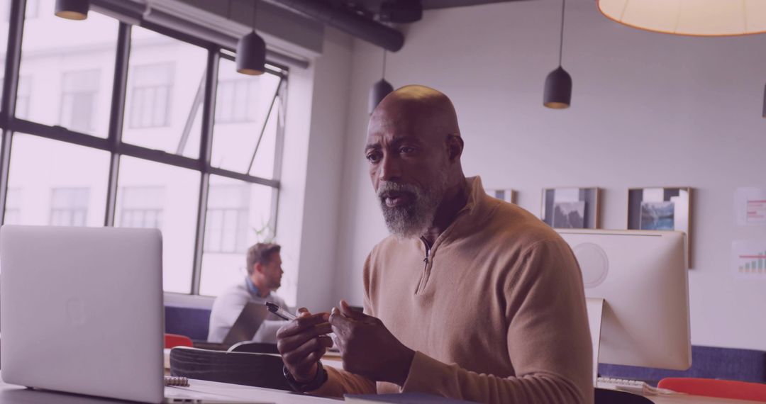 Middle-aged Professional Man Collaborating at Modern Office Desk