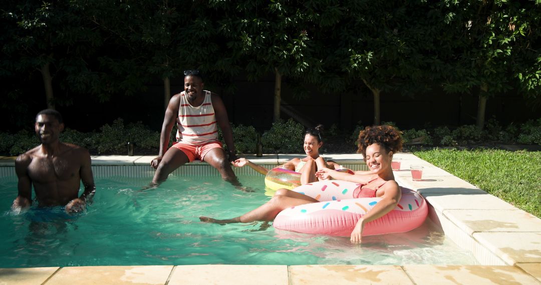Diverse Friends Enjoying Summer Pool Time with Inflatable Rings