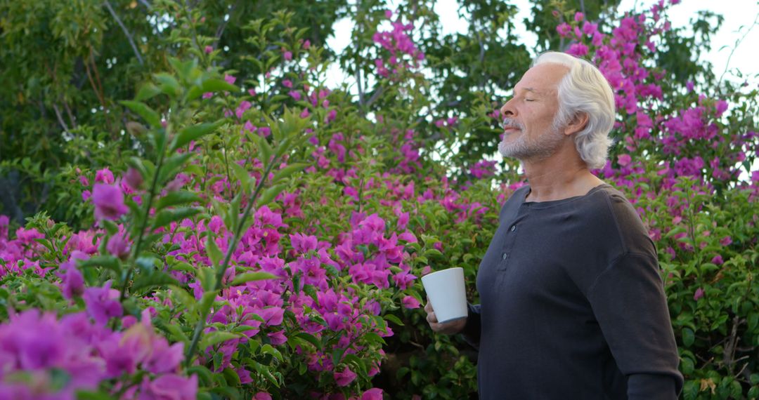 Caucasian Man Savoring Morning Coffee in Lush Garden - Free Images, Stock Photos and Pictures on Pikwizard.com