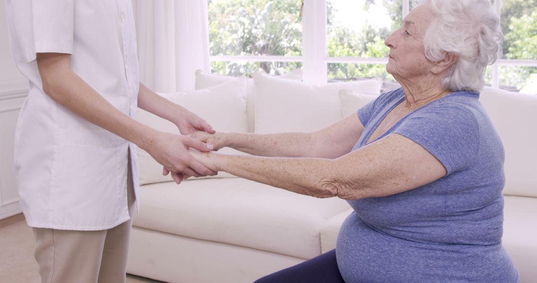 Caregiver Assisting Elderly Woman During Physical Therapy Session - Free Images, Stock Photos and Pictures on Pikwizard.com