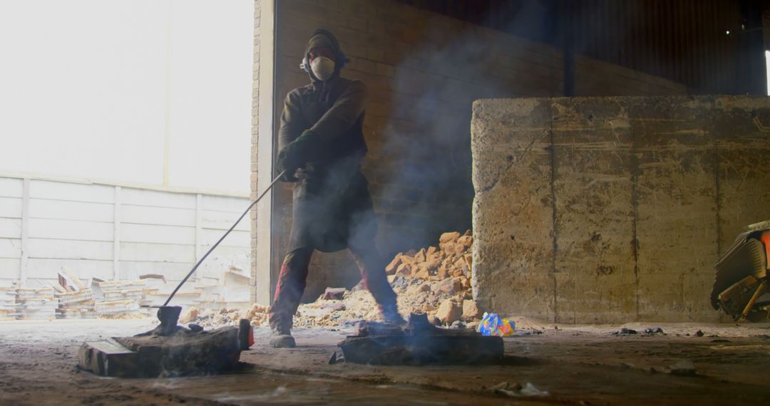 Worker in Protective Gear Tending Smelting Furnace in Industrial Factory - Free Images, Stock Photos and Pictures on Pikwizard.com