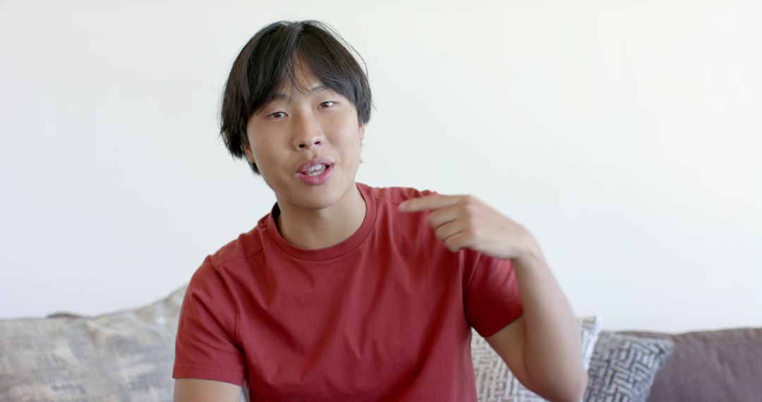 Relaxed College Student on Couch in Red Shirt