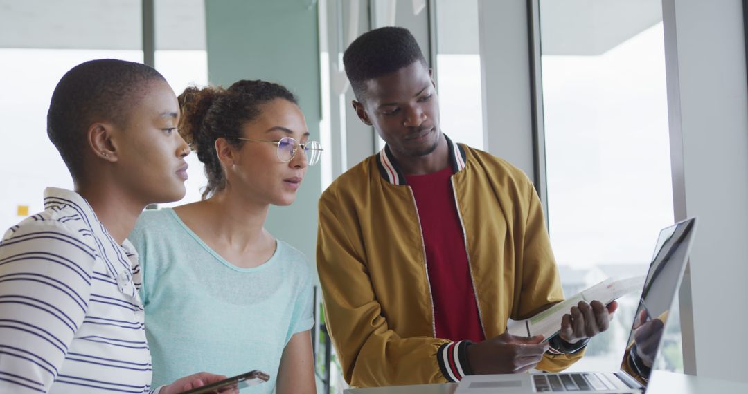 Diverse Team Collaborating on Project at Modern Office