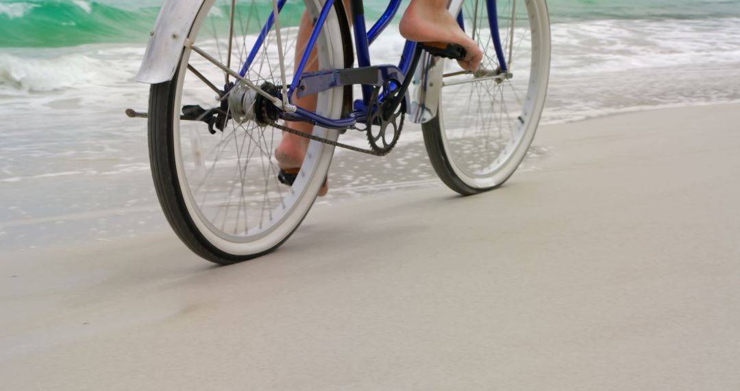 Person Riding Bicycle Along Sea Shoreline in Relaxing Environment