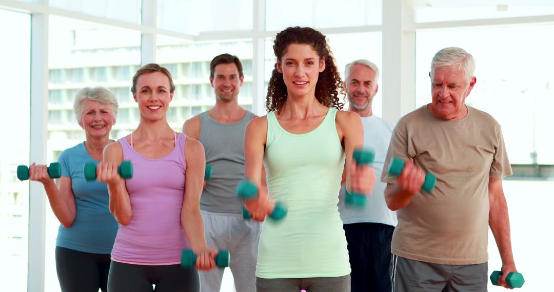 Group of Adults Exercising with Dumbbells in Fitness Class - Free Images, Stock Photos and Pictures on Pikwizard.com