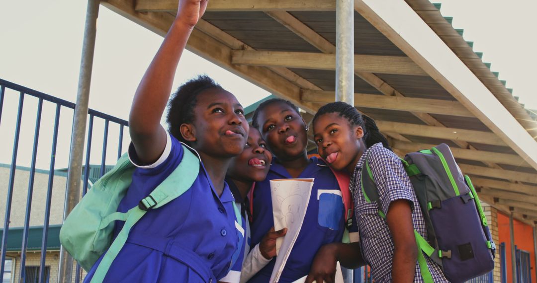 Group of Schoolgirls Taking Selfie Together Outdoors
