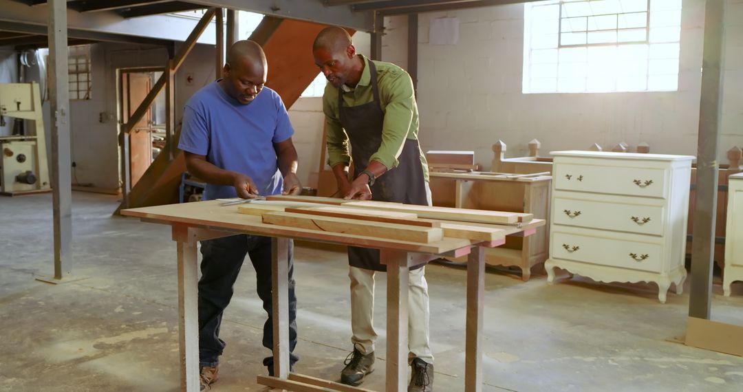 African American Colleagues Measuring Wood in Workshop