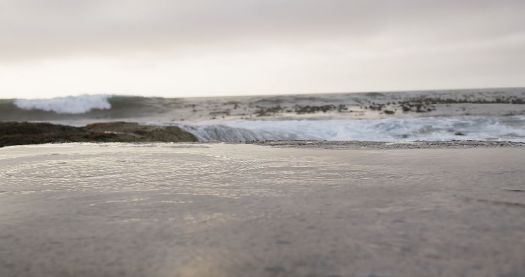 Crashing Ocean Waves Against Rugged Shoreline at Dusk