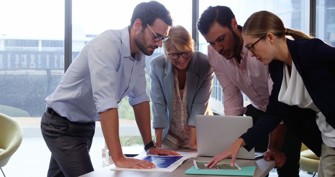 Team Collaborating Over Business Report in Modern Office