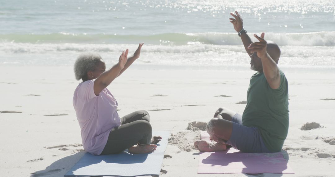 Senior couple practicing yoga by sea, morning wellness exercise on beach - Free Images, Stock Photos and Pictures on Pikwizard.com