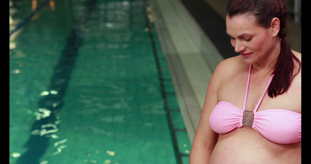 Pregnant Woman in Pink Bikini by Swimming Pool Reflecting - Free Images, Stock Photos and Pictures on Pikwizard.com