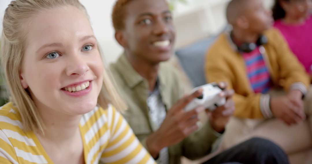 Happy Teens Playing Video Games Together on Couch - Free Images, Stock Photos and Pictures on Pikwizard.com