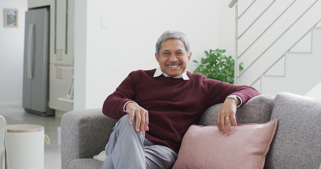 Elderly Man Relaxing on Couch in Modern Home Interior - Free Images, Stock Photos and Pictures on Pikwizard.com