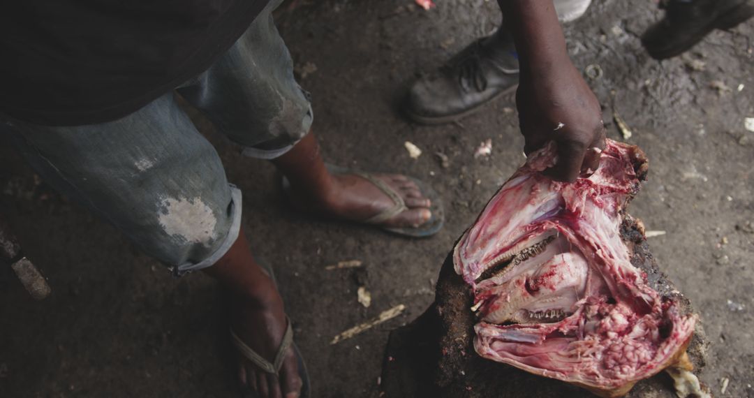 Butcher Holding Raw Meat on Wooden Block in Workshop - Free Images, Stock Photos and Pictures on Pikwizard.com