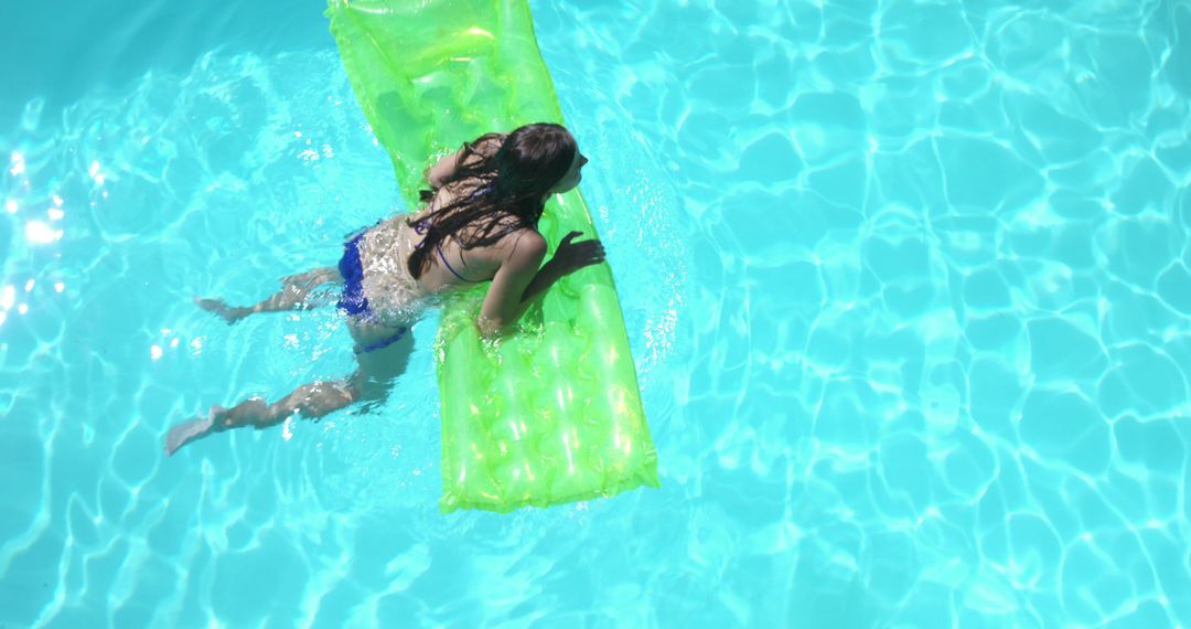 Woman Relaxing on Green Inflatable in Blue Swimming Pool - Free Images, Stock Photos and Pictures on Pikwizard.com