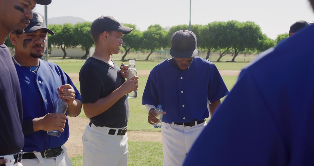 Baseball Team Hydrating During Break on Field - Free Images, Stock Photos and Pictures on Pikwizard.com