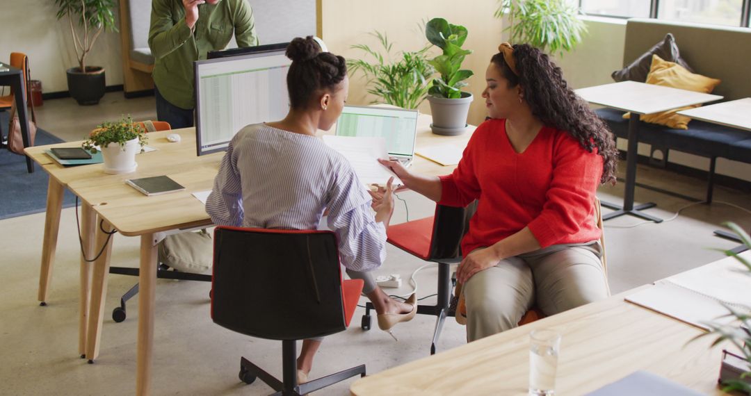 Diverse Team Brainstorming Together in Modern Office