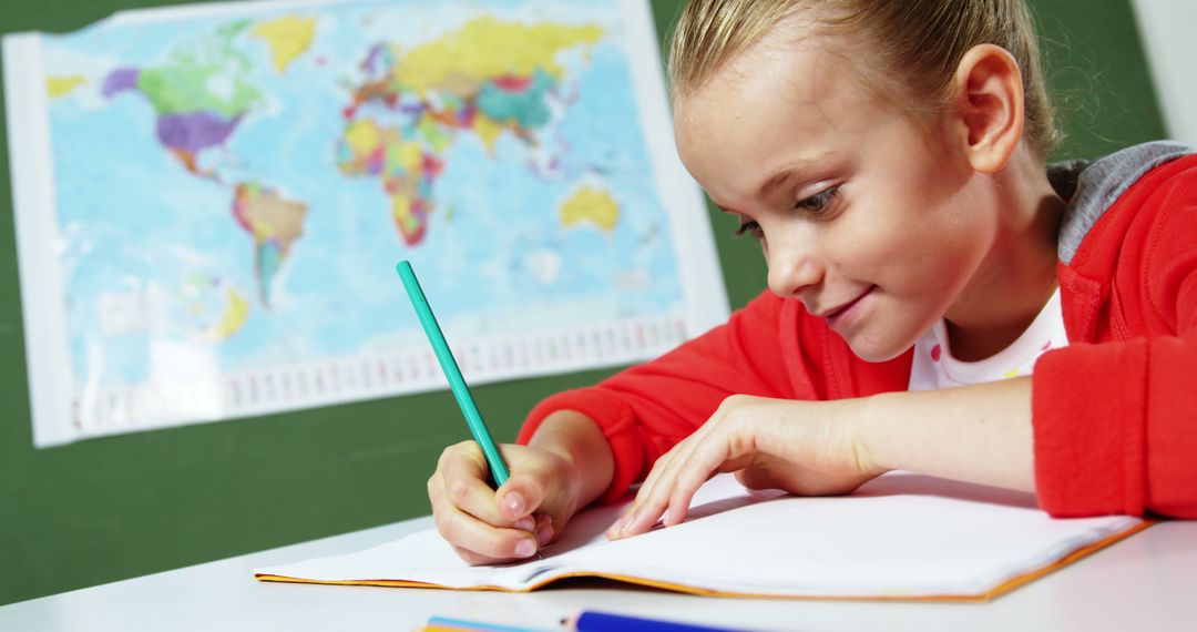 Young Schoolgirl Studying at Desk with Map
