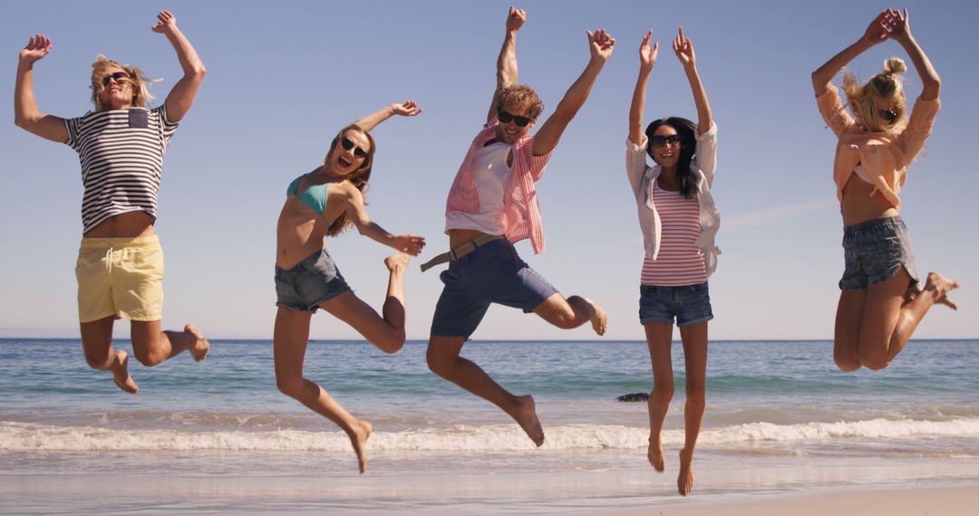 Friends Jumping Joyfully on Beach Vacation - Free Images, Stock Photos and Pictures on Pikwizard.com