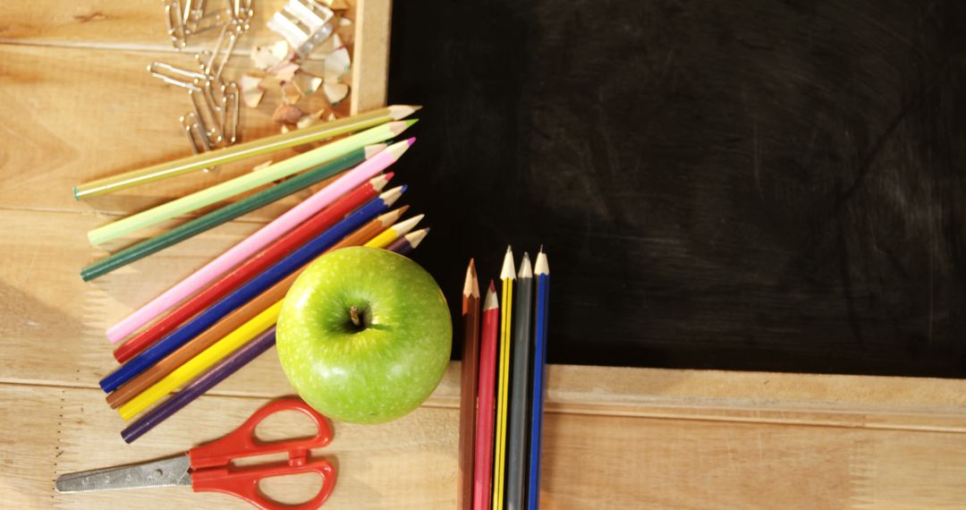 Back-to-School Essentials on Wooden Desk with Blackboard