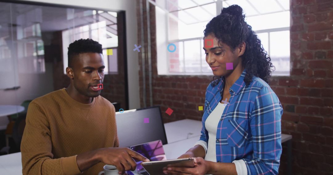 Colleagues Collaborating Over Tablet in Modern Brick Office Space