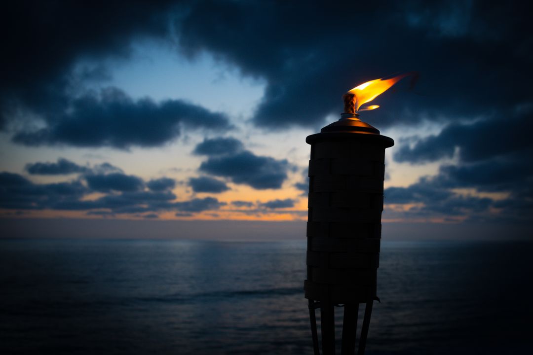 Tiki Torch Lighting Sunset Over Calm Ocean - Free Images, Stock Photos and Pictures on Pikwizard.com