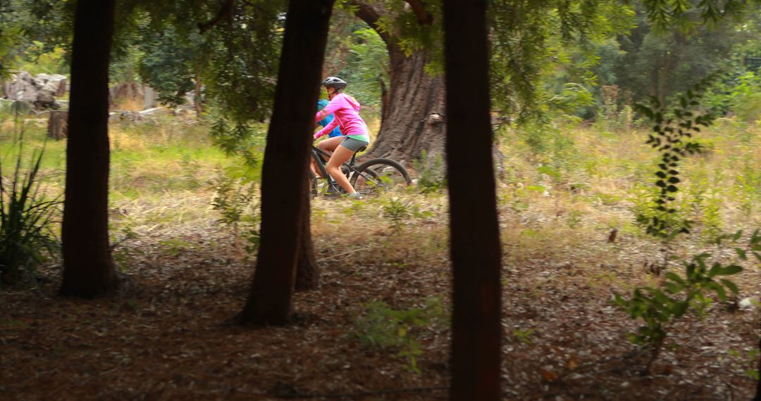 Woman Riding Bicycle in Woodland Area - Free Images, Stock Photos and Pictures on Pikwizard.com