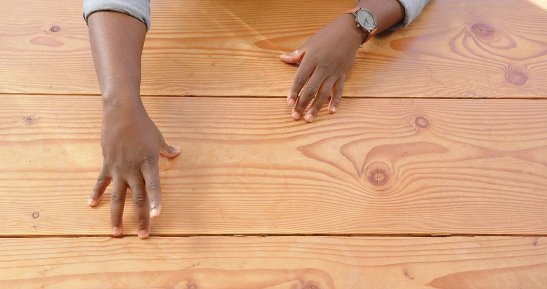 Hands with Wristwatch Over Wooden Surface Gesturing in Casual Setting