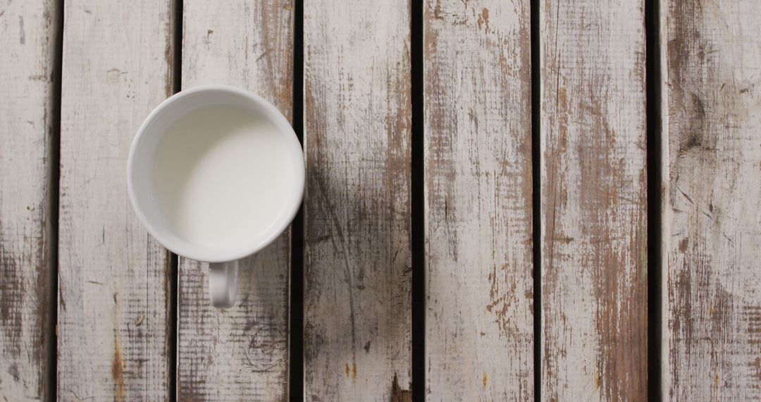 Top View of Milk in White Cup on Rustic Wood Table - Free Images, Stock Photos and Pictures on Pikwizard.com