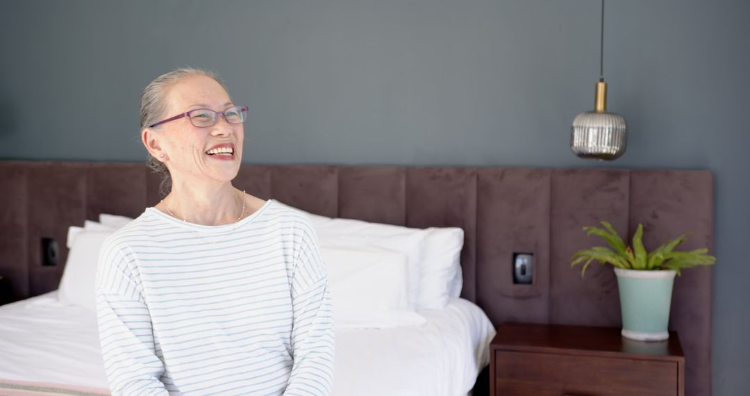 Senior Woman Smiling in Minimalist Bedroom Setting