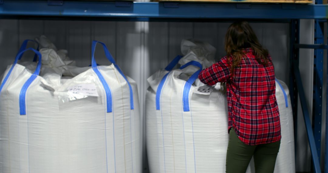 Warehouse Worker Inspects Bulk Container Bags
