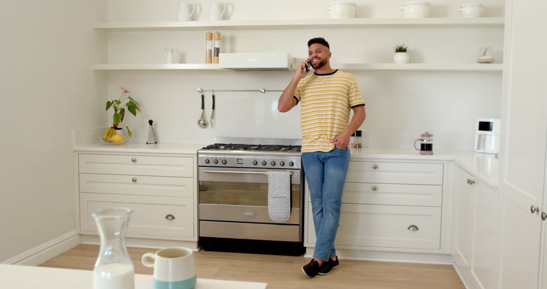 Man Talking on Smartphone in Modern Minimalist Kitchen