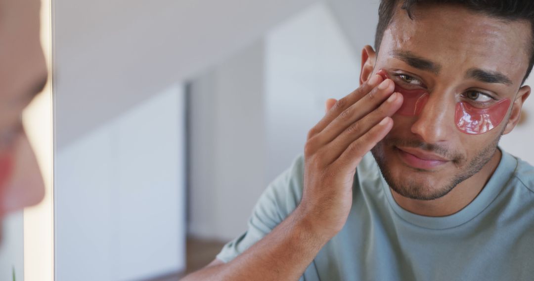 Man Applying Red Under-Eye Patches for Skin Care - Free Images, Stock Photos and Pictures on Pikwizard.com