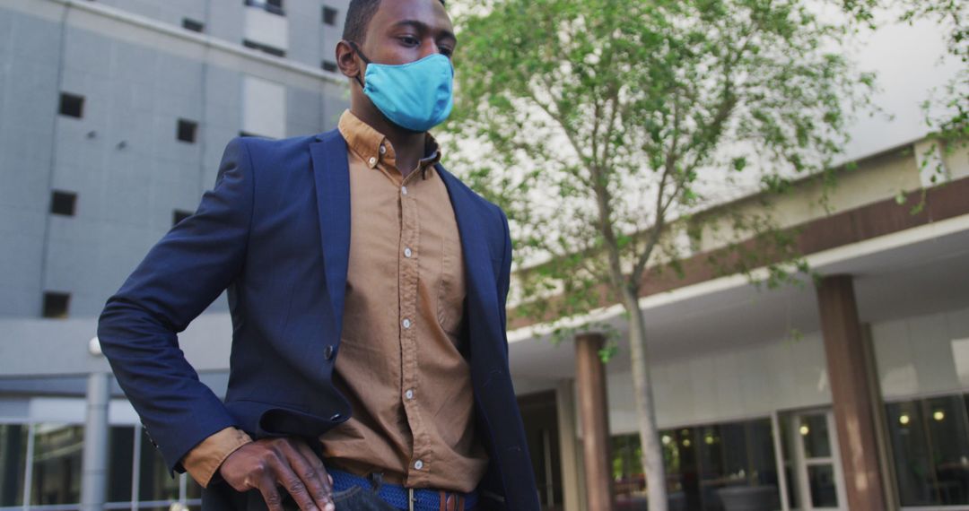 Professional Man Wearing Blue Mask Walking Outdoors - Free Images, Stock Photos and Pictures on Pikwizard.com