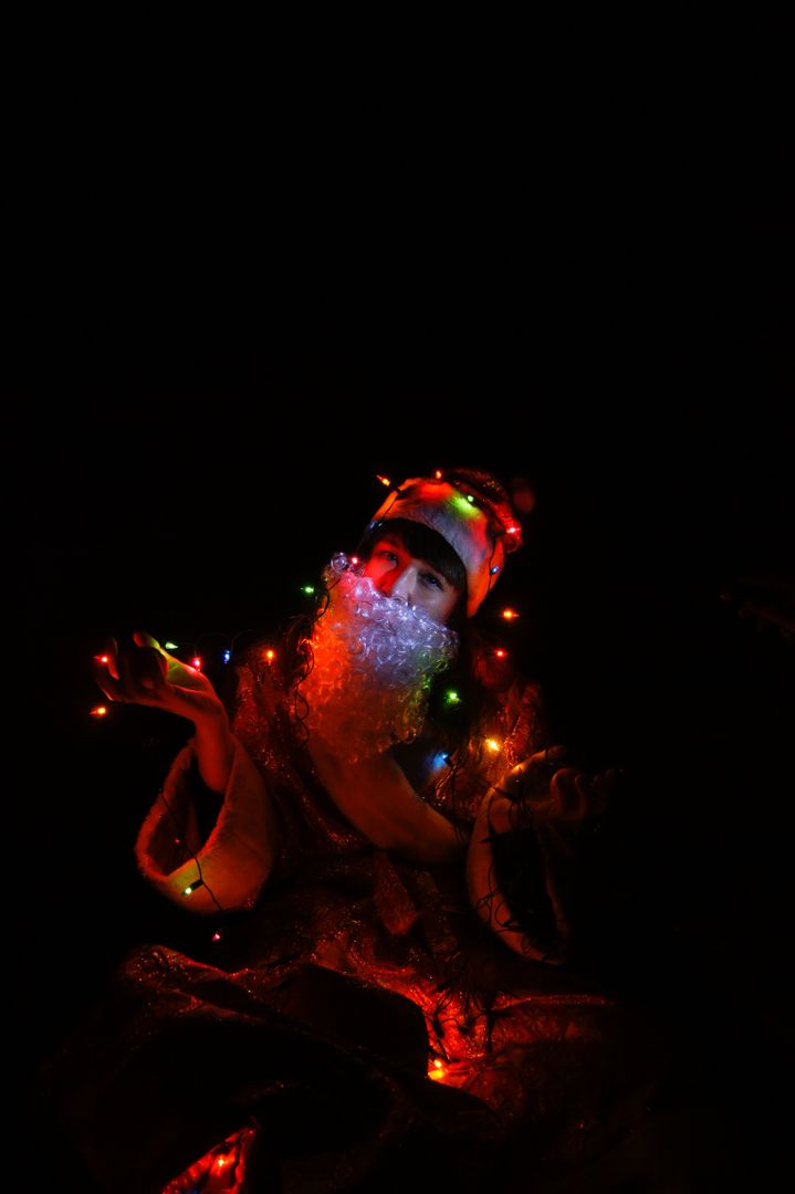 Santa Claus with Christmas Lights in Dark Room - Free Images, Stock Photos and Pictures on Pikwizard.com