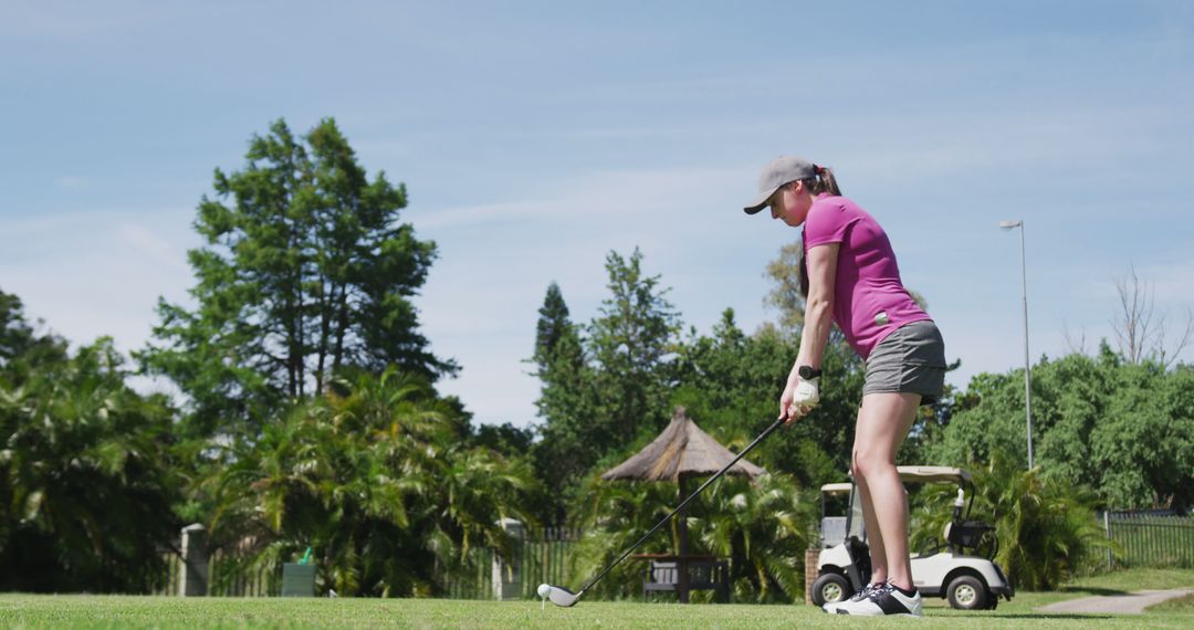 Female Golfer in Action on Lush Green Course
