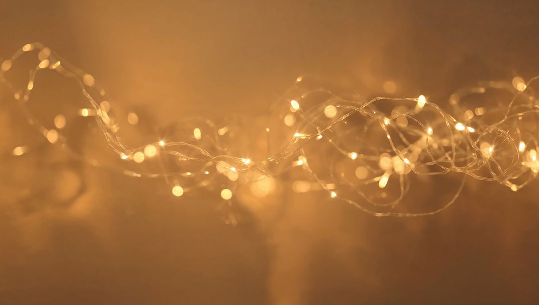 Warm Golden Fairy Lights String Creating Soft Bokeh Glow for Holiday and Ambient Backgrounds