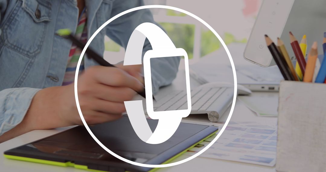 Graphic Designer Using Tablet with Smartwatch Icon Overlay