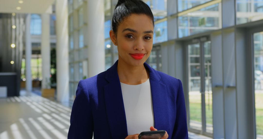 Confident Professional Standing in Modern Office Hallway